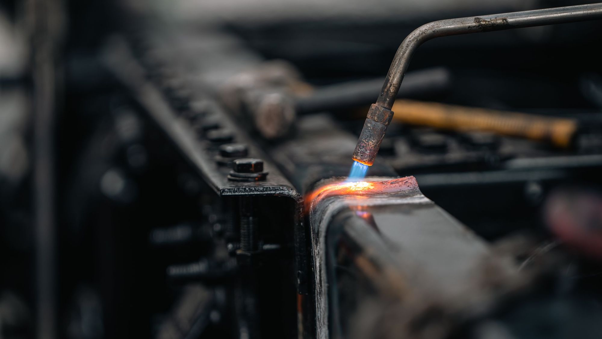 Close-up of a torch flame brazing metal