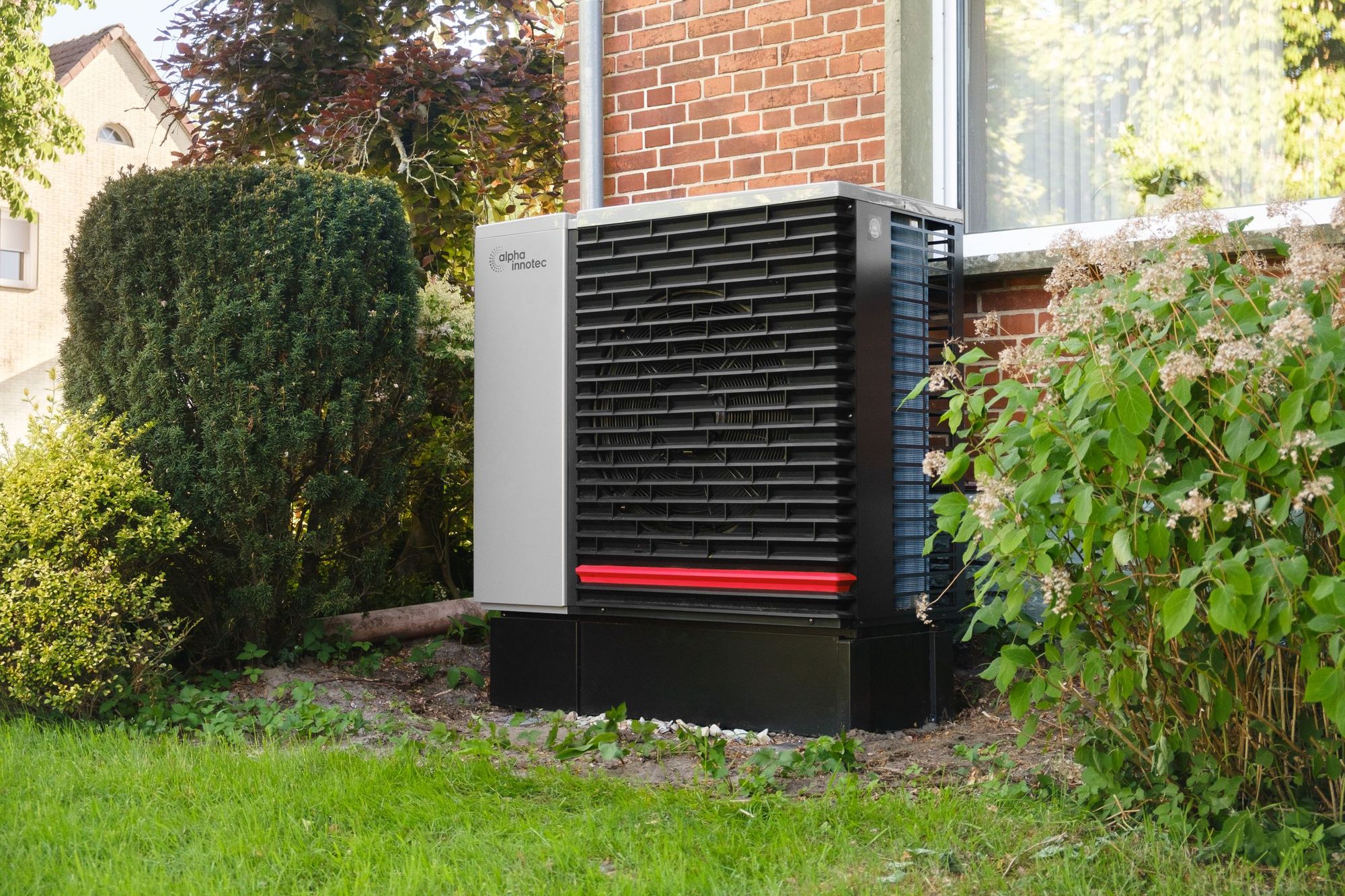 An outdoor heat pump unit in a green residential yard