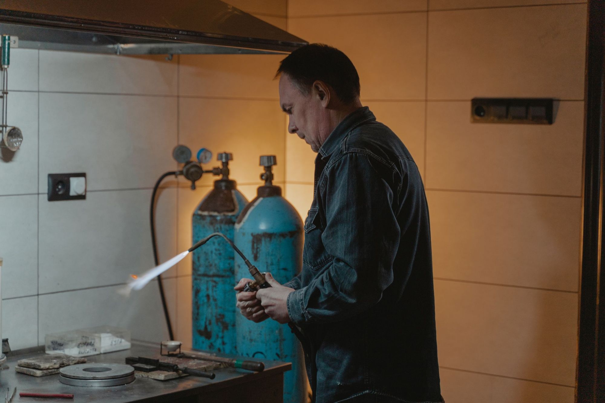 An HVAC technician brazing a copper line with a torch